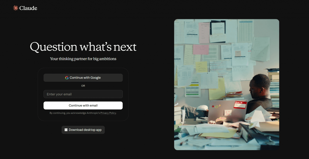Web page login screenshot for Claude AI featuring the headline "Question what's next", login options via Google or email, a desktop app download button, and a photo of a person working at a desk covered in papers.