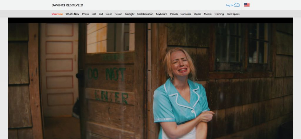 Web page landing screenshot for DaVinci Resolve 21 featuring top navigation links and a full-bleed cinematic video frame showing an blonde woman in a teal uniform crying outside a rustic wooden building labeled DO NOT ENTER.